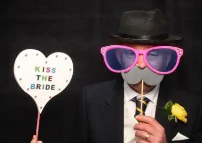 Kiss the bride or miss the bride! Great disguise using the photo booth props