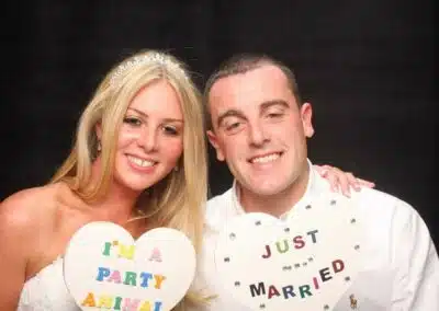 A pair of party animals -just married using the photo booth