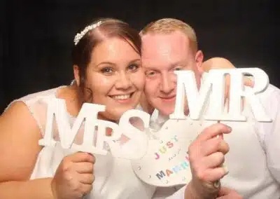 Photo booths at wedding receptions - a new mr and mrs pose in the photo booths at their wedding reception